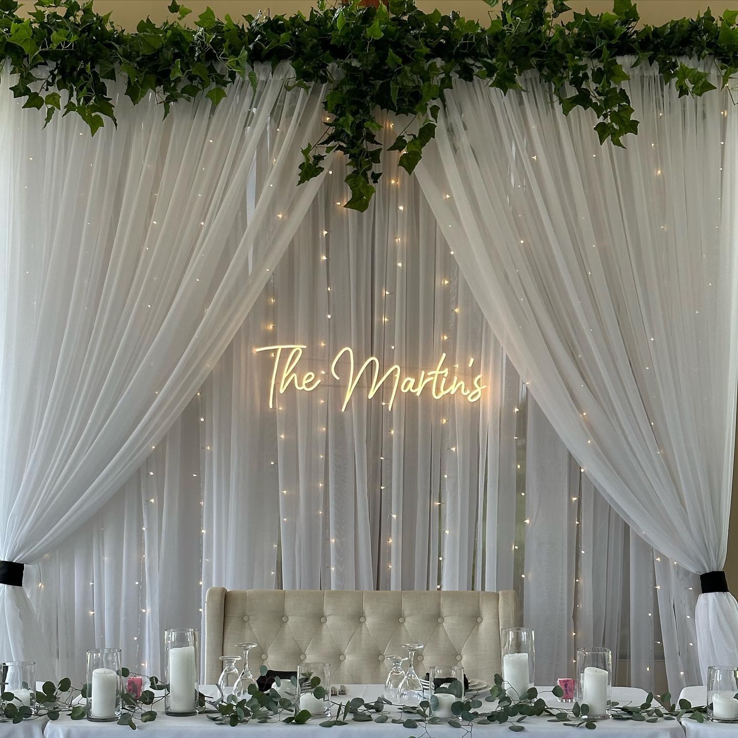 Decorative event setup with flowers and drapes
